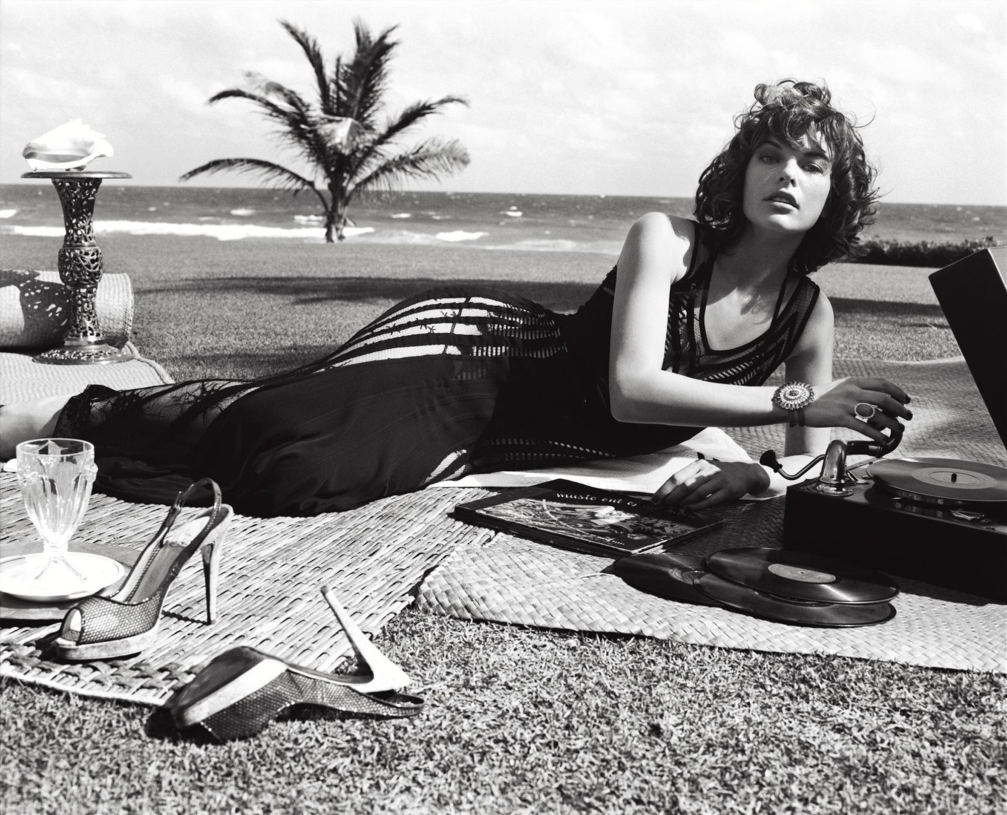 Woman on beach with record player