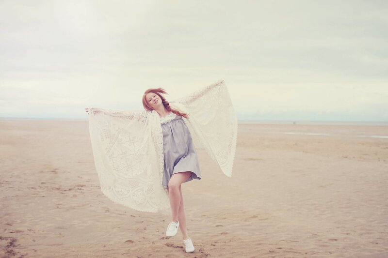 woman on beach with scarf