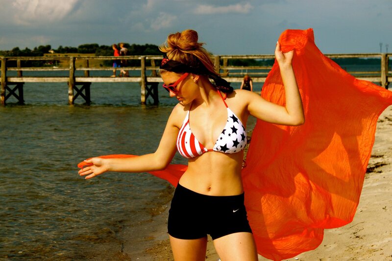 Woman on beach with scarf