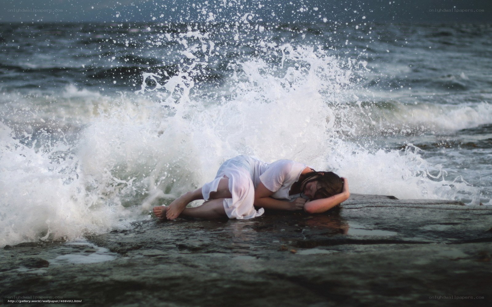 Woman on beach with wave
