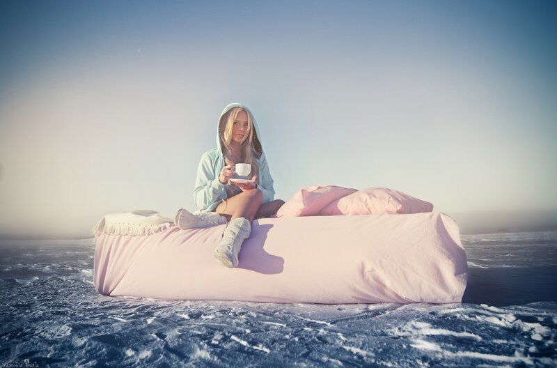woman on bed in snowy landscape