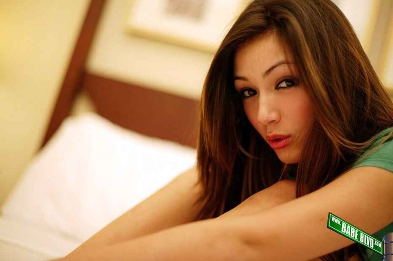 woman on bed with green shirt