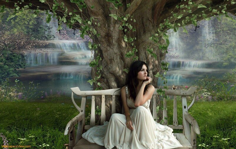 Woman on bench by waterfall