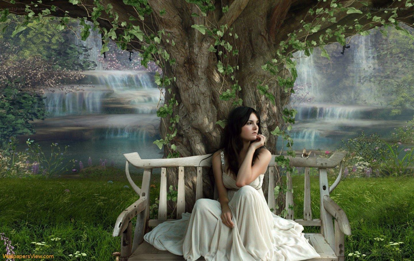 Woman on bench by waterfall