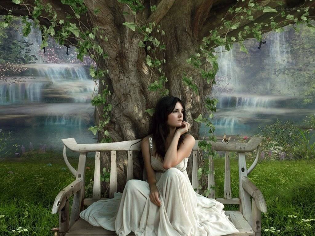 Woman on bench by waterfall
