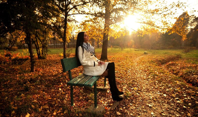 Woman on bench in autumn park
