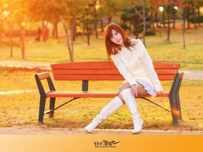 Woman on bench in autumn park