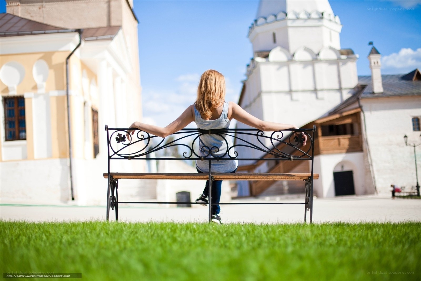 Woman on bench in historic square