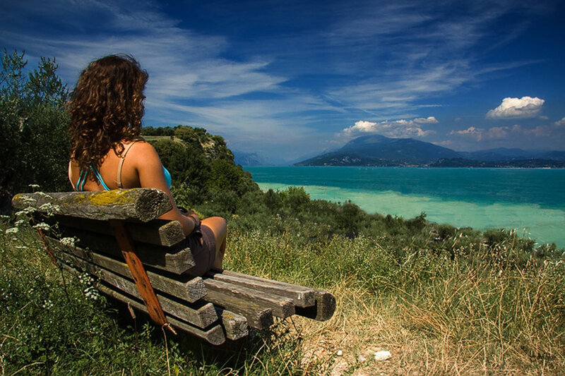 Woman on bench overlooking lake