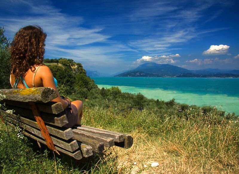 Woman on bench overlooking lake