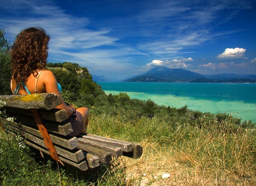 Woman on bench overlooking lake