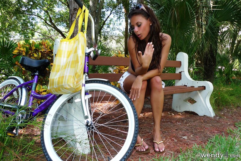 Woman on bench with bicycle