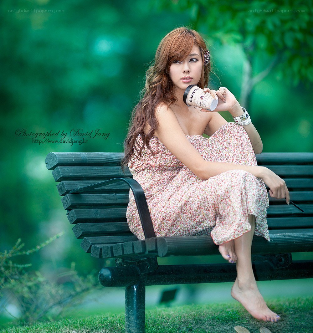 Woman on bench with coffee