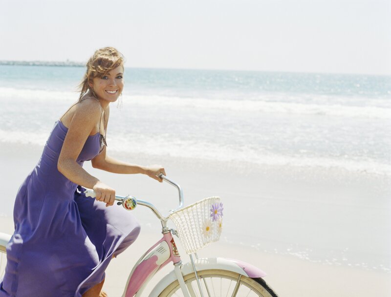 Woman on bicycle at the beach