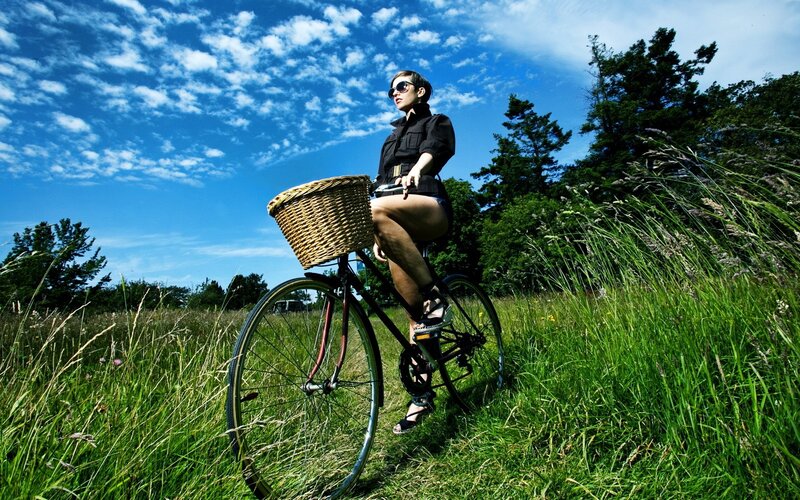 Woman on bicycle in field