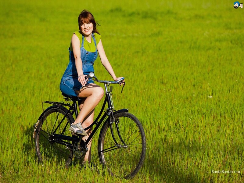 Woman on bicycle in field