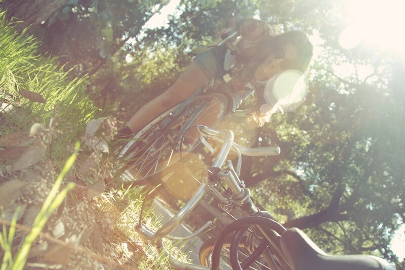woman on bicycle in sunlight