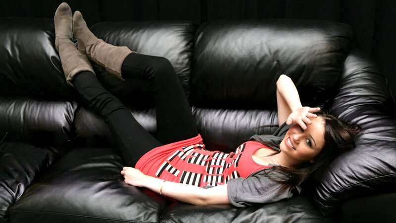 Woman on Black Couch — Relaxed, Photograph, Boots
