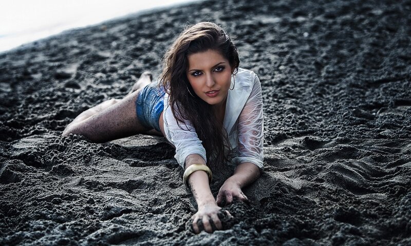 woman on black sand beach
