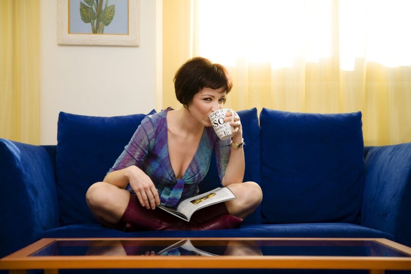 Woman on Blue Couch — Relaxed, Morning