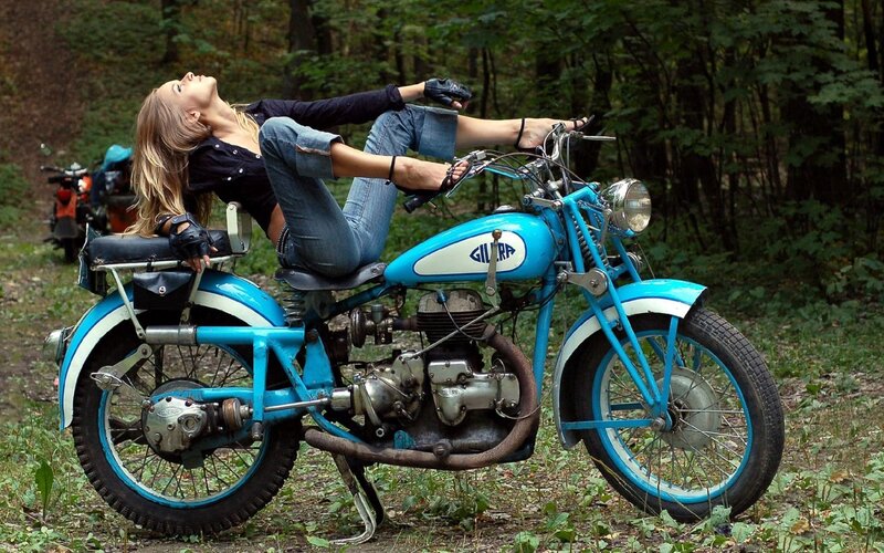 Woman on blue motorcycle