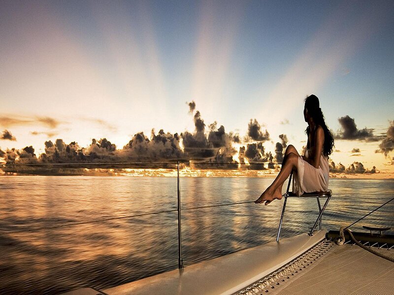 Woman on boat at sunset