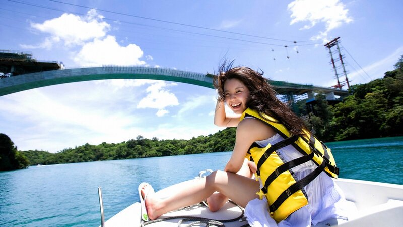 Woman on boat under bridge