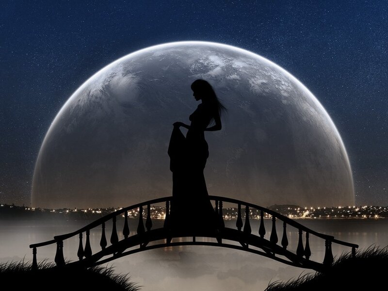 woman on bridge under giant moon