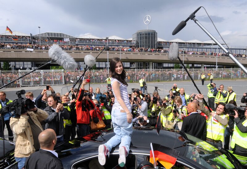 Woman on car at race track
