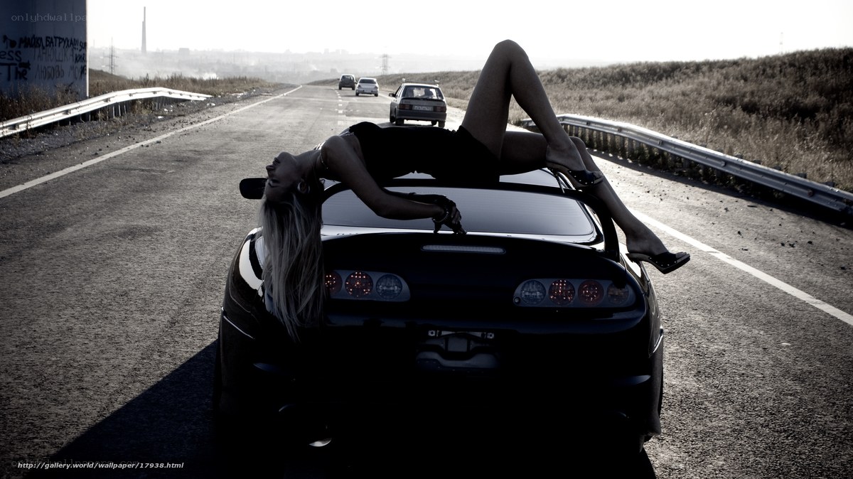 woman on car roof on highway
