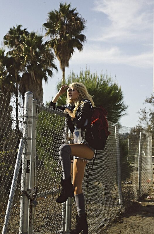 Woman on chain-link fence