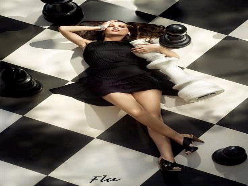 Woman on chessboard with pieces
