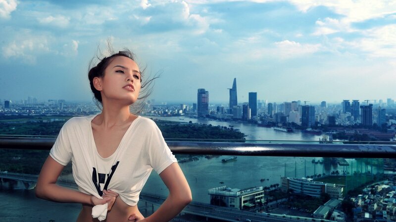 Woman on city balcony