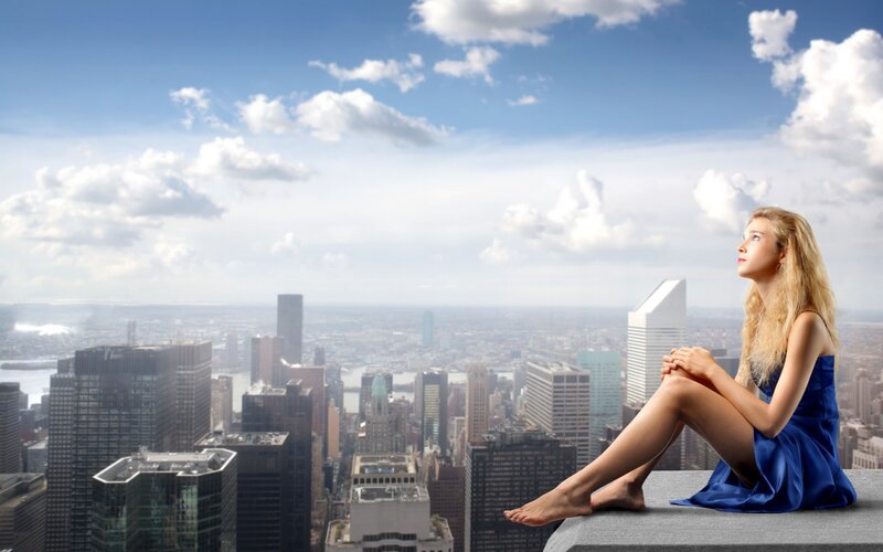 Woman on city rooftop