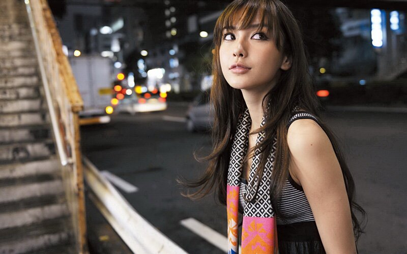 woman on city street at night