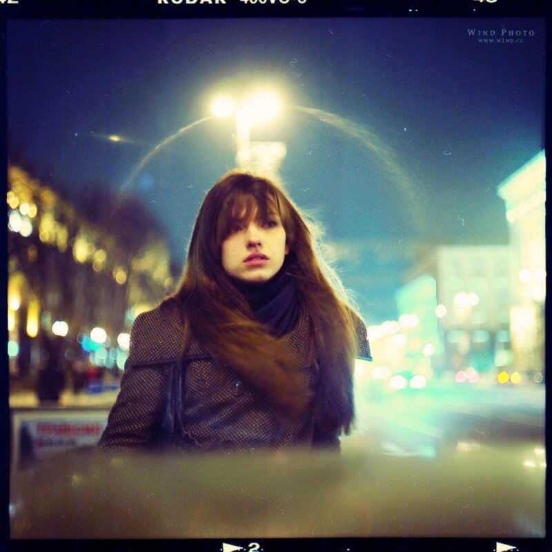 woman on city street at night
