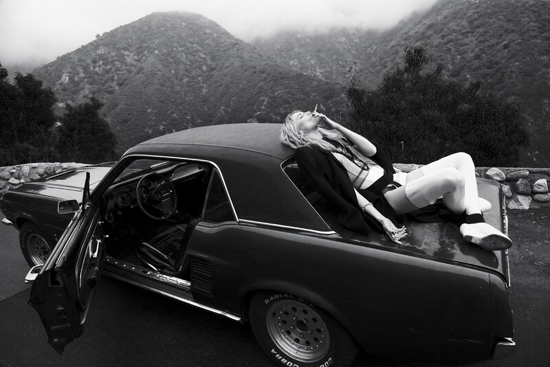 Woman on classic car hood