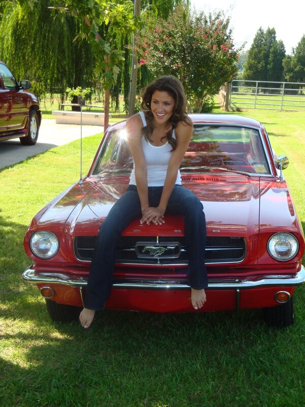 Woman on classic red car