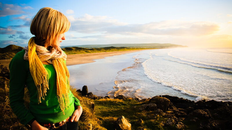 Woman on Cliff Overlooking Beach — Green