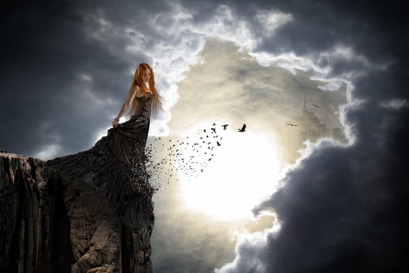woman on cliff with birds
