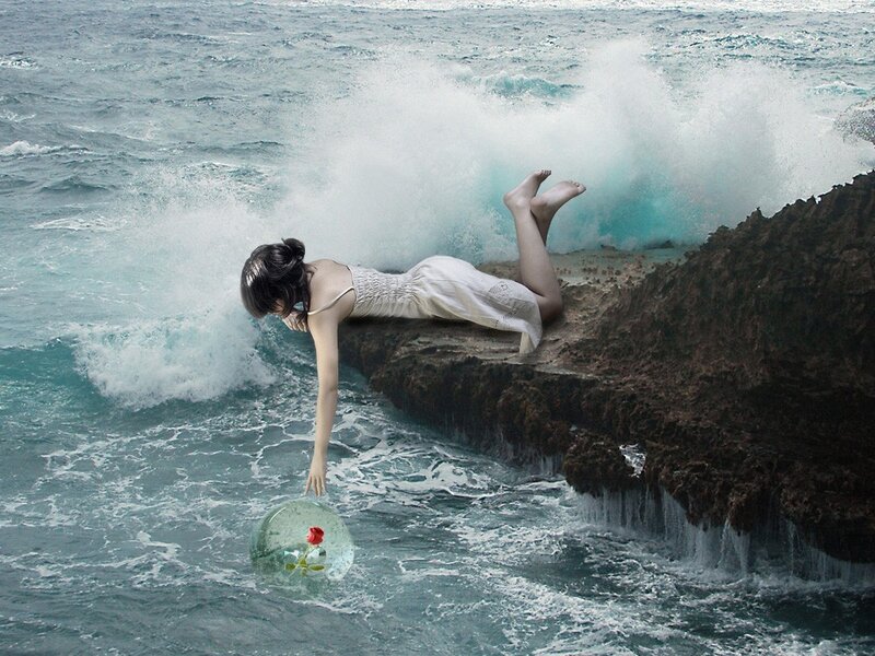 woman on cliff with rose