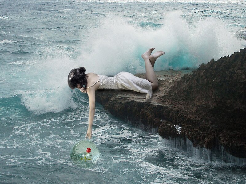 woman on cliff with rose