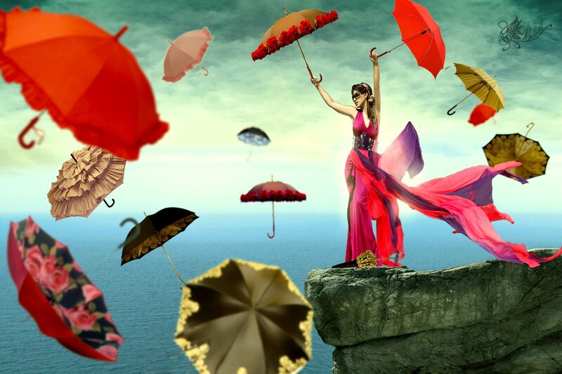 Woman on Cliff with Umbrellas