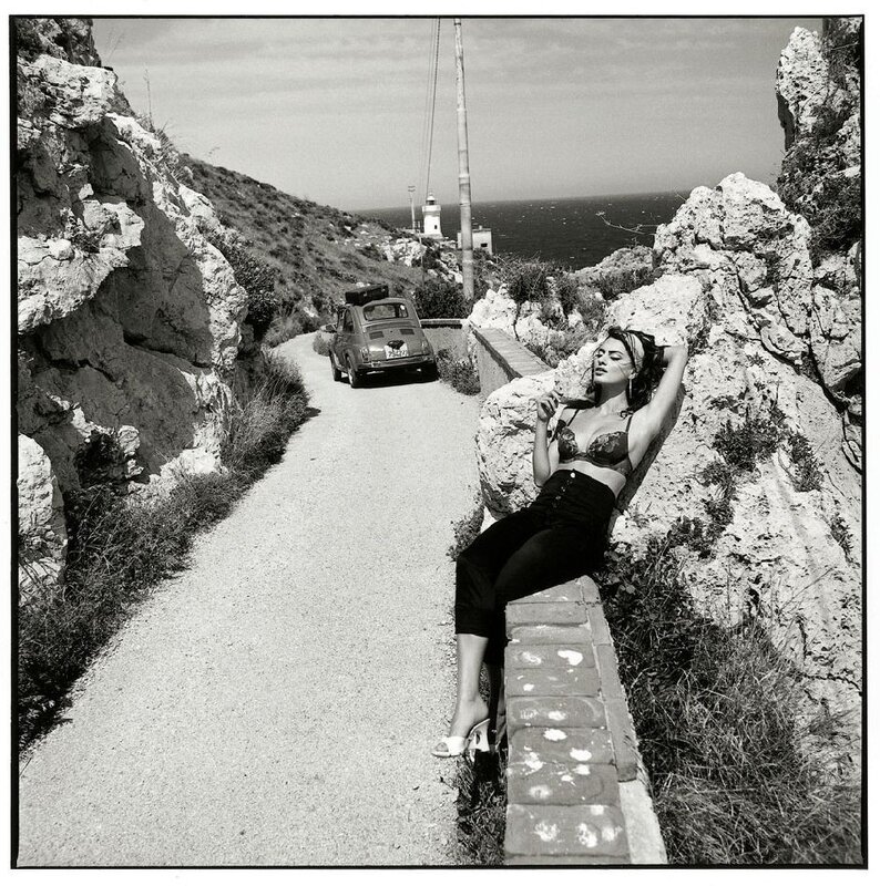 Woman on coastal path with car