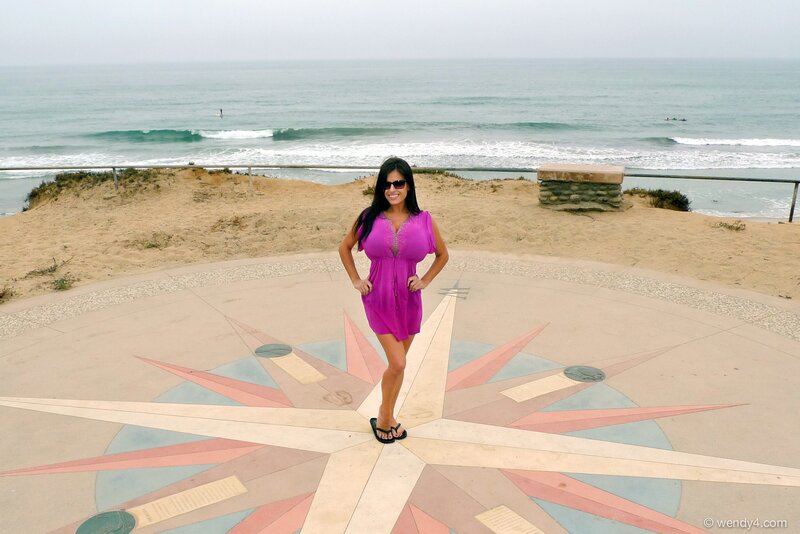 Woman on compass at beach