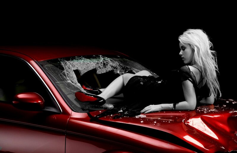 Woman on damaged red car