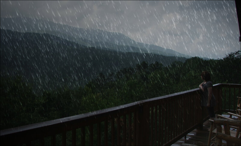 Woman on deck in rainstorm