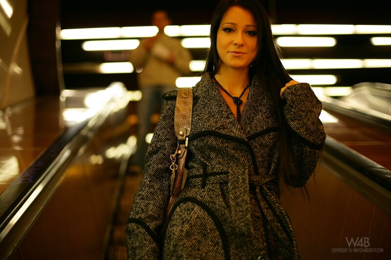 Woman on escalator in coat