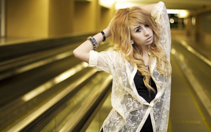 woman on escalator in lace jacket