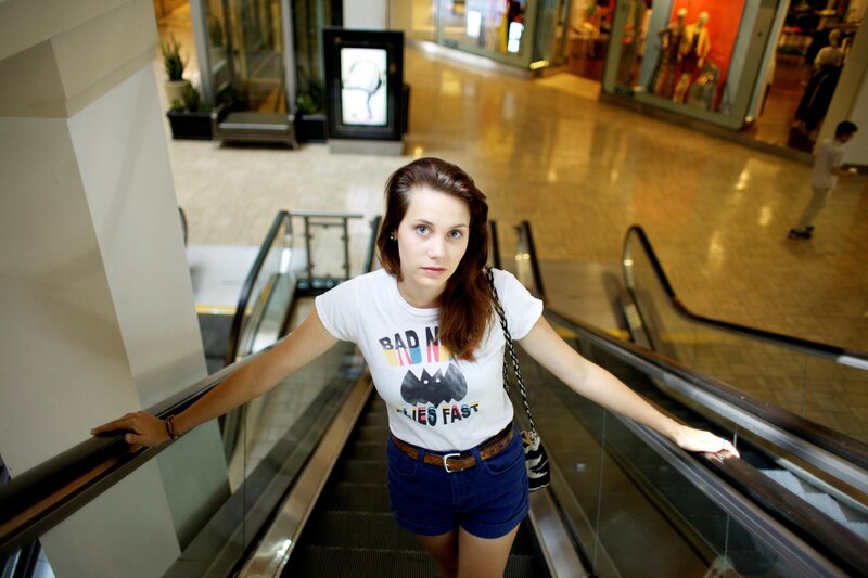 Woman on escalator in mall